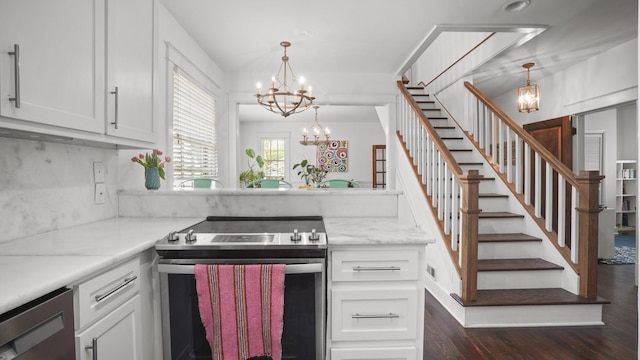 kitchen featuring white cabinetry, stainless steel range with electric stovetop, light countertops, dark wood-style floors, and a notable chandelier