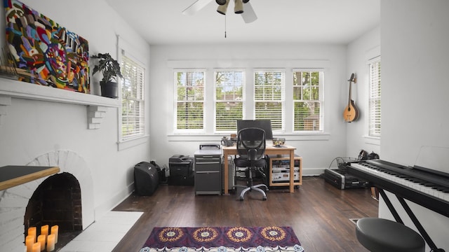home office with a healthy amount of sunlight, a ceiling fan, and dark wood finished floors