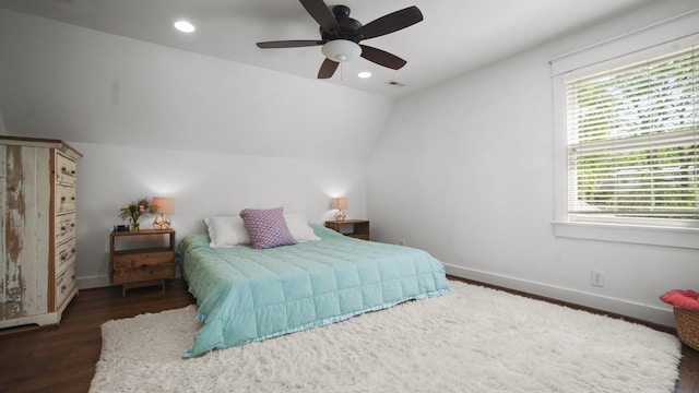 bedroom featuring lofted ceiling, visible vents, wood finished floors, and baseboards