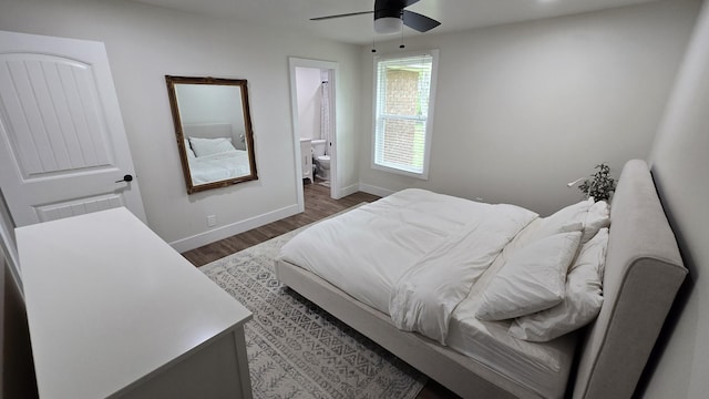 bedroom featuring baseboards, ceiling fan, connected bathroom, and dark wood-type flooring