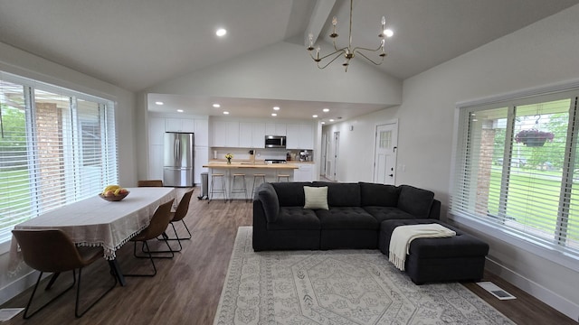 living room with wood finished floors, a chandelier, a healthy amount of sunlight, and visible vents