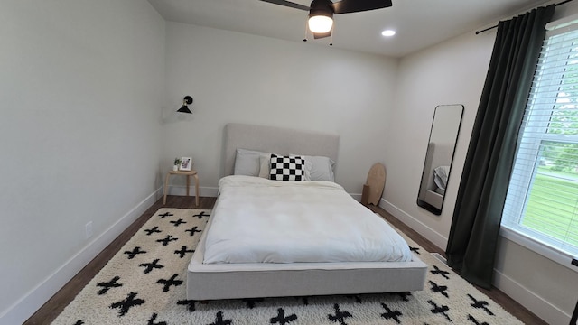 bedroom featuring recessed lighting, ceiling fan, wood finished floors, and baseboards