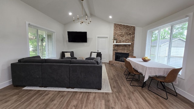 living room with wood finished floors, plenty of natural light, and baseboards