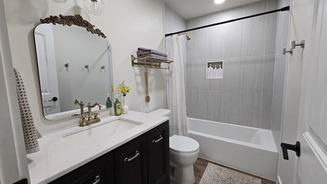 bathroom featuring shower / bath combo, vanity, toilet, and wood finished floors