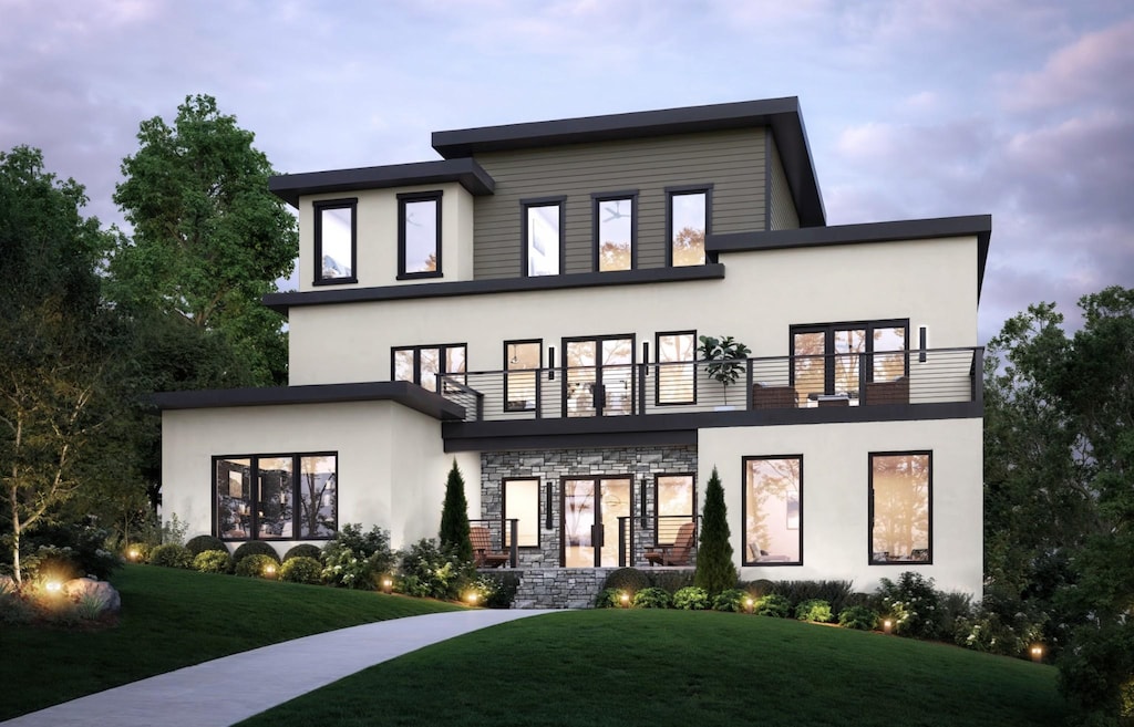 rear view of property featuring stucco siding, a yard, and a balcony