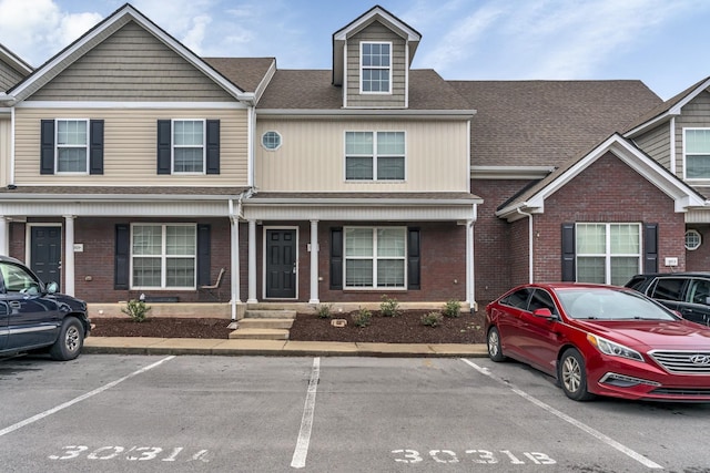 3031 Rg Buchanan Dr, La Vergne, TN 37086 - view of property with uncovered parking, brick siding, and roof with shingles
