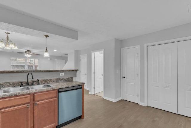 3031 Rg Buchanan Dr, La Vergne, TN 37086 - kitchen with light wood-style flooring, a sink, baseboards, dishwasher, and hanging light fixtures