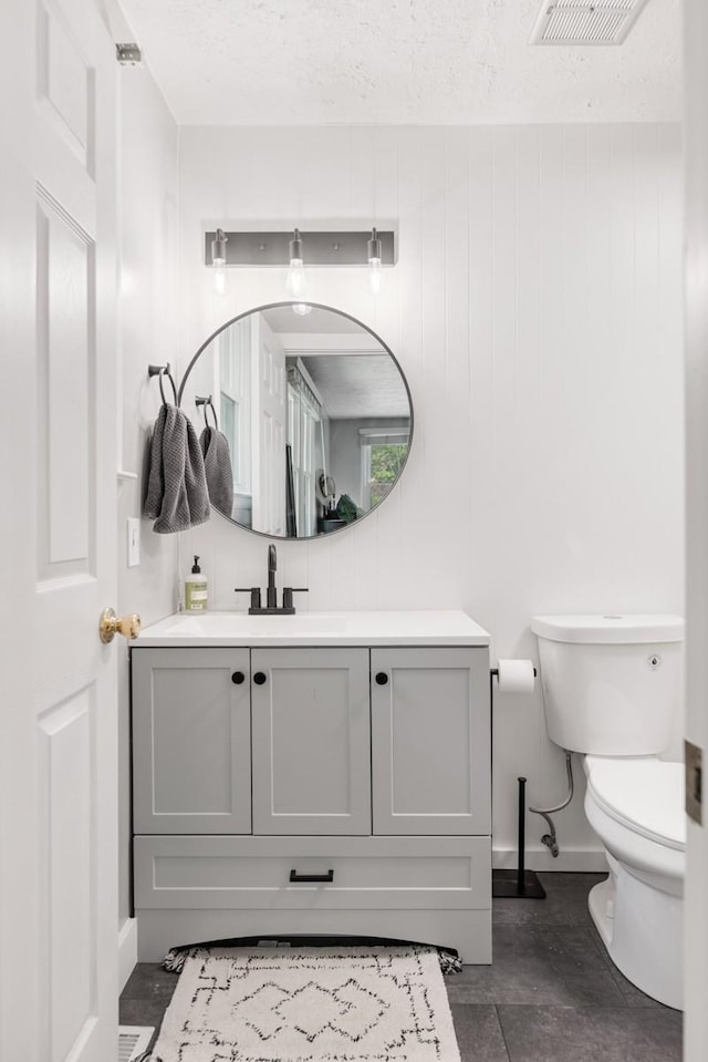 5070 Ridge Rd, Joelton, TN 37080 - bathroom with vanity, toilet, visible vents, baseboards, and a textured ceiling