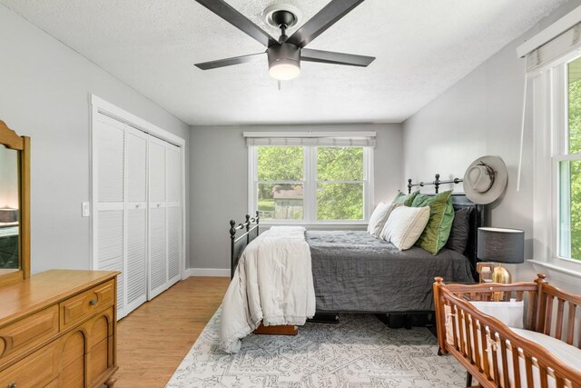 5070 Ridge Rd, Joelton, TN 37080 - bedroom with a textured ceiling, light wood-type flooring, a ceiling fan, and a closet