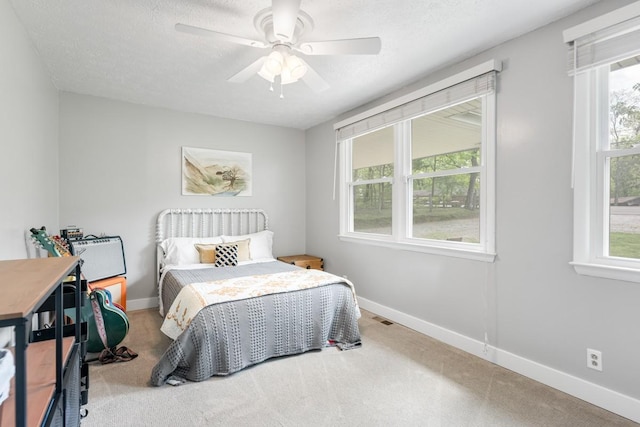5070 Ridge Rd, Joelton, TN 37080 - carpeted bedroom with visible vents, ceiling fan, and baseboards
