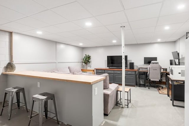 5070 Ridge Rd, Joelton, TN 37080 - kitchen featuring concrete floors, a breakfast bar, wooden counters, and a peninsula