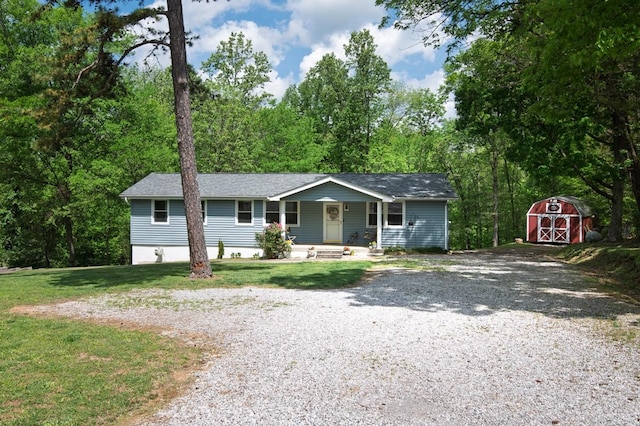 5070 Ridge Rd, Joelton, TN 37080 - single story home featuring covered porch, a storage unit, an outdoor structure, and driveway