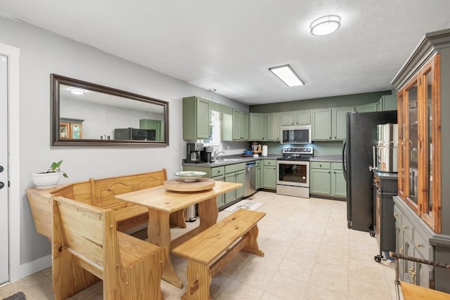 5070 Ridge Rd, Joelton, TN 37080 - kitchen featuring stainless steel appliances, a sink, and green cabinets