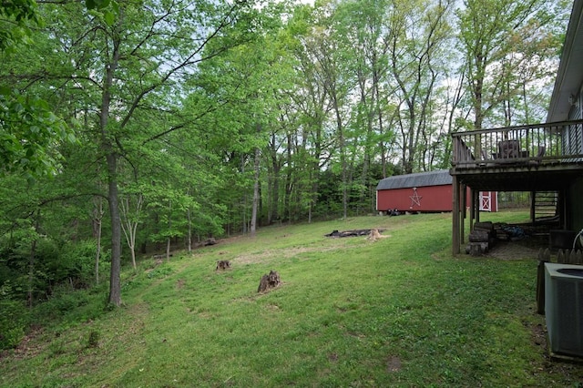 5070 Ridge Rd, Joelton, TN 37080 - view of yard featuring a deck, an outbuilding, central AC, and a view of trees