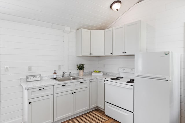 10931 Beechcraft Rd, Bon Aqua, TN 37025 - kitchen featuring white appliances, light stone countertops, a sink, light wood-style flooring, and vaulted ceiling