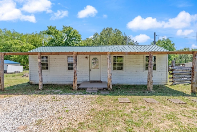 10931 Beechcraft Rd, Bon Aqua, TN 37025 - view of front facade featuring fence, a front yard, and metal roof