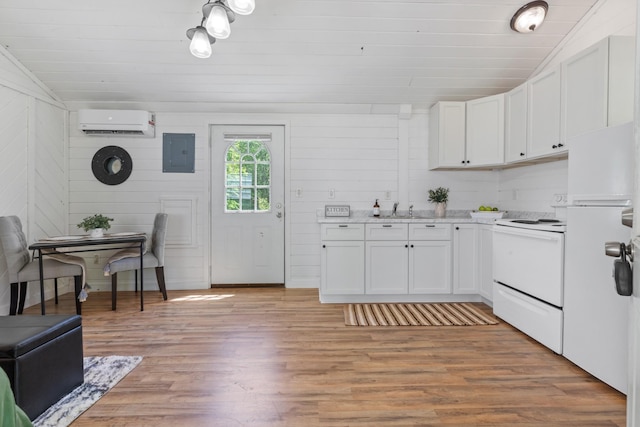 10931 Beechcraft Rd, Bon Aqua, TN 37025 - kitchen featuring a wall unit AC, electric panel, light countertops, light wood finished floors, and white appliances