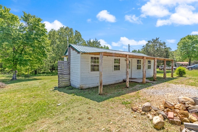 10931 Beechcraft Rd, Bon Aqua, TN 37025 - rear view of property featuring a yard and metal roof