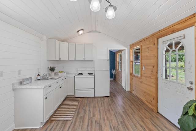 10931 Beechcraft Rd, Bon Aqua, TN 37025 - kitchen featuring white electric stove, wood walls, a sink, lofted ceiling, and white cabinetry