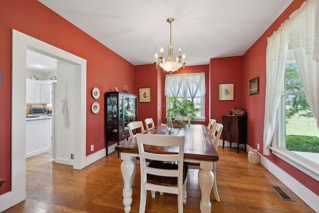 1494 Grant Rd, Watertown, TN 37184 - dining space with a chandelier, visible vents, plenty of natural light, and light wood-style flooring