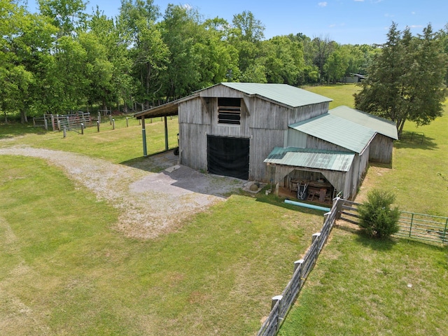 1494 Grant Rd, Watertown, TN 37184 - view of pole building with a lawn, fence, and driveway