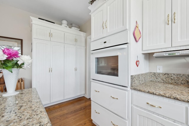 1494 Grant Rd, Watertown, TN 37184 - kitchen featuring white cabinets, wood finished floors, and white oven