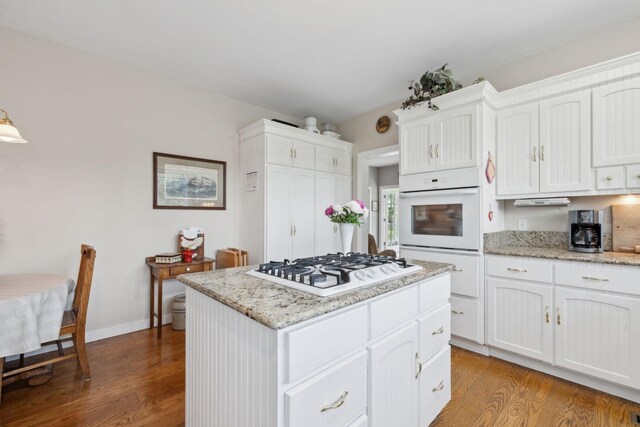 1494 Grant Rd, Watertown, TN 37184 - kitchen featuring light wood-type flooring, a kitchen island, white cabinets, and white appliances