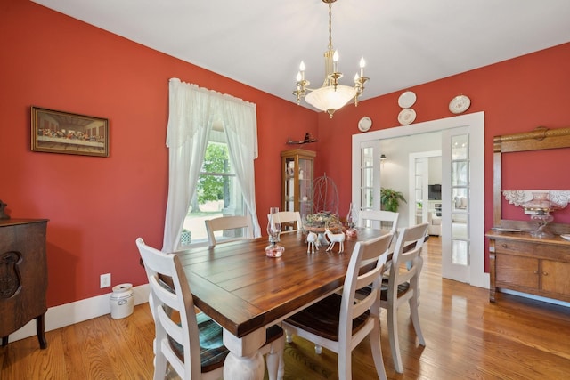 1494 Grant Rd, Watertown, TN 37184 - dining area featuring baseboards, wood finished floors, and a notable chandelier