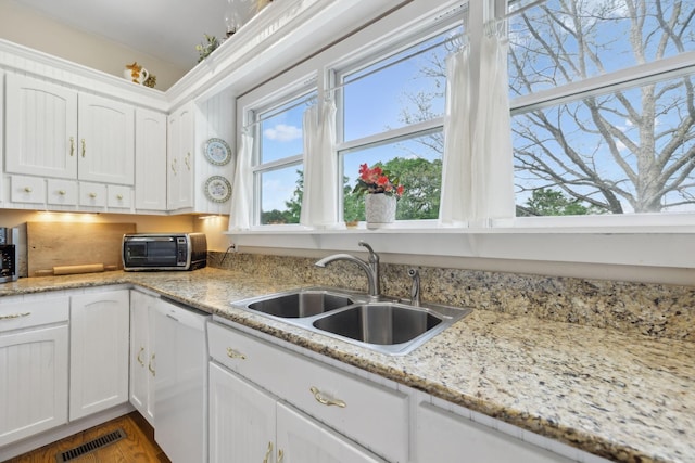 1494 Grant Rd, Watertown, TN 37184 - kitchen featuring white cabinets, a sink, dishwasher, a toaster, and visible vents