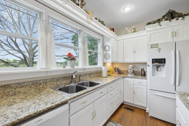 1494 Grant Rd, Watertown, TN 37184 - kitchen with light wood-style floors, a sink, white cabinets, and white appliances