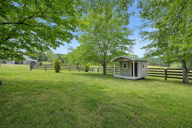 1494 Grant Rd, Watertown, TN 37184 - view of yard with a fenced backyard, a storage unit, and an outbuilding
