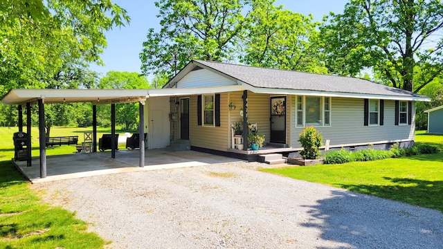4471 Seminary Rd, Smyrna, TN 37167 - view of front of house featuring a porch, a carport, a front yard, and dirt driveway