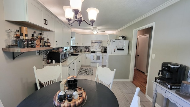 4471 Seminary Rd, Smyrna, TN 37167 - dining space with crown molding, light wood-style flooring, and ceiling fan with notable chandelier