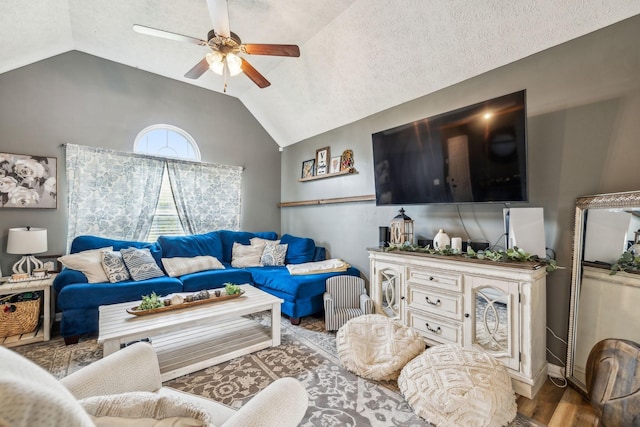 living area featuring wood finished floors, ceiling fan, and vaulted ceiling