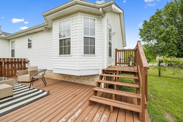 deck featuring fence and a yard