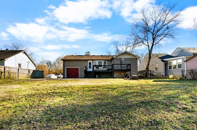 rear view of property with a deck, a garage, and a chimney