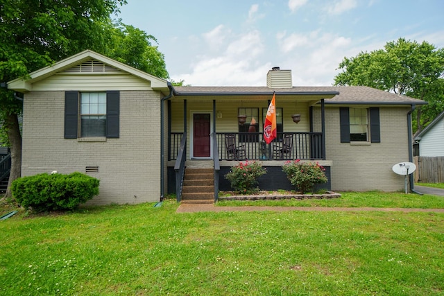 single story home featuring covered porch, a chimney, brick siding, and a front lawn
