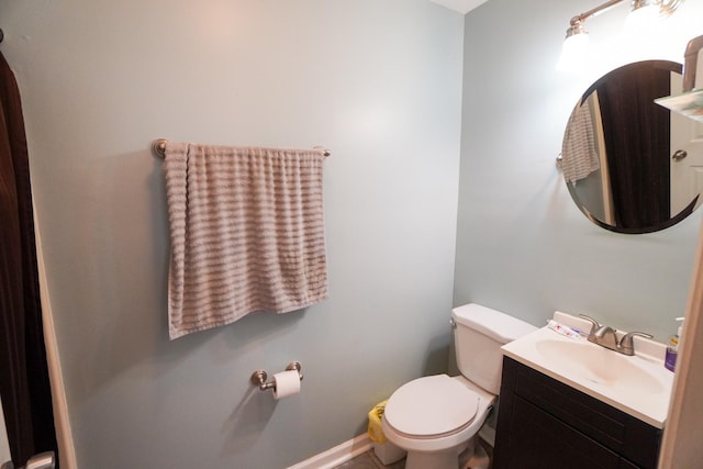 bathroom featuring toilet and vanity