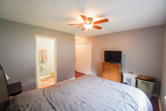 bedroom featuring connected bathroom, a ceiling fan, a closet, and baseboards