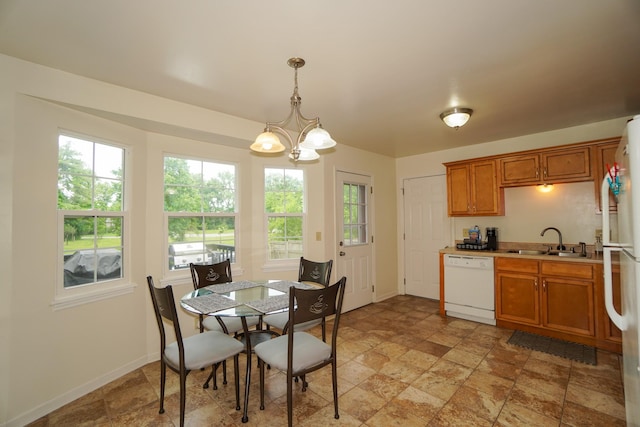 dining room with light stone finish flooring, a chandelier, and baseboards