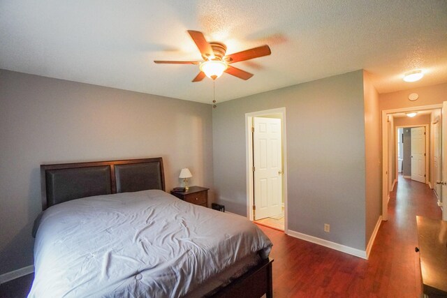 bedroom with wood finished floors, baseboards, and ceiling fan