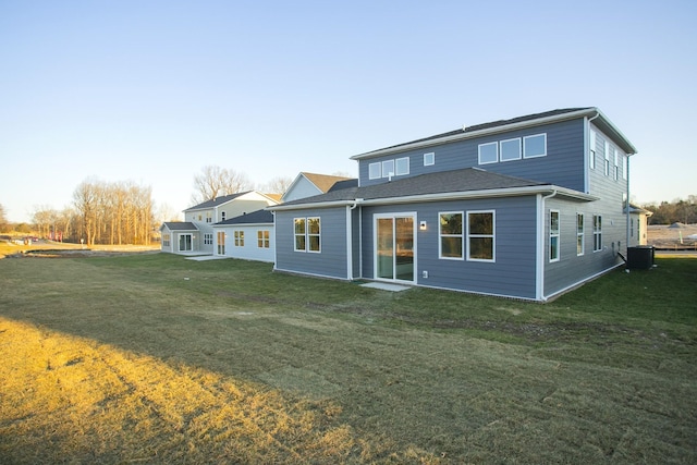 rear view of property with a lawn