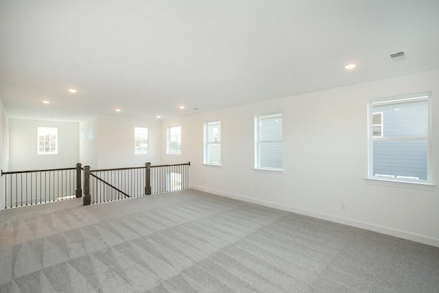 spare room with recessed lighting and carpet