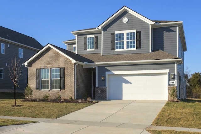 view of front of home featuring a front yard, concrete driveway, a garage, and brick siding