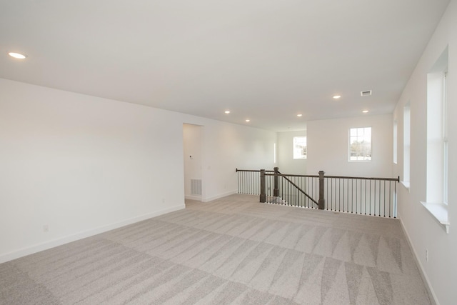 unfurnished room featuring visible vents, recessed lighting, and light carpet
