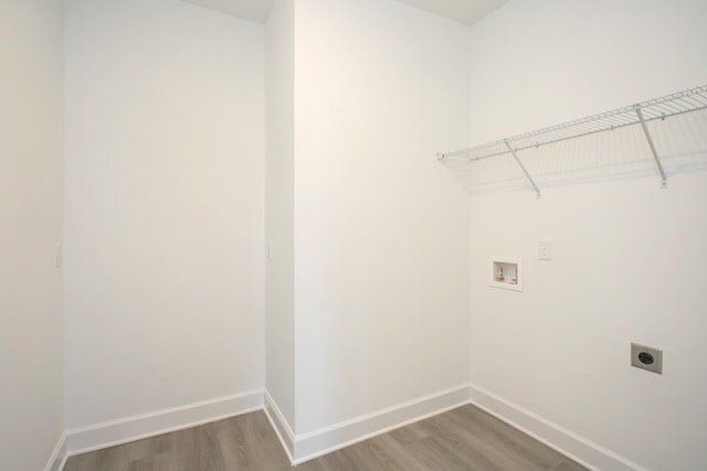 laundry area featuring hookup for an electric dryer, laundry area, hookup for a washing machine, baseboards, and wood finished floors