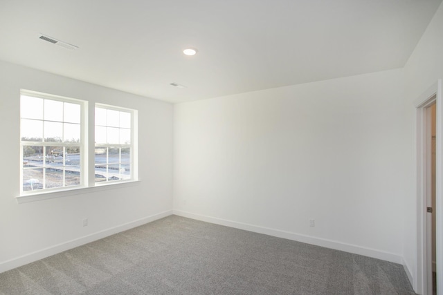 spare room with visible vents, baseboards, recessed lighting, and carpet floors