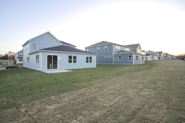 back of property featuring a yard and a patio area
