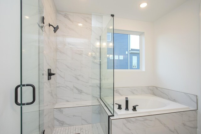 bathroom featuring a bath, recessed lighting, and a shower stall