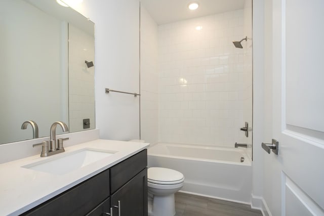 bathroom with recessed lighting, vanity, shower / bath combination, toilet, and wood finished floors